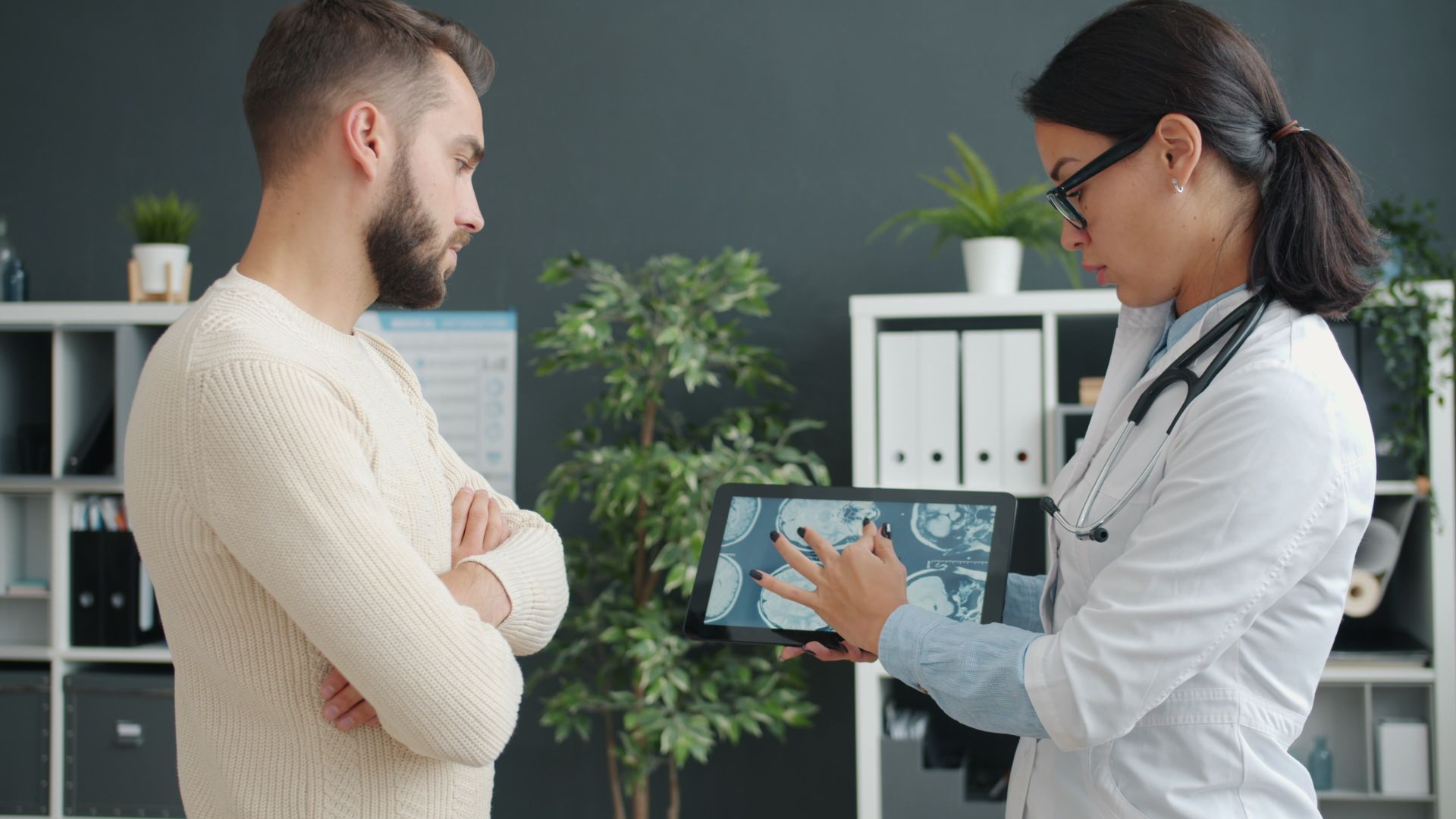 Clinician explaining results to a patient on a tablet